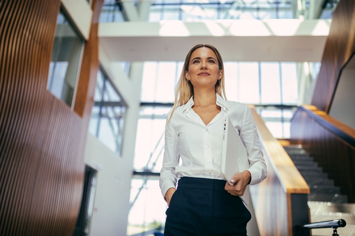 Lady in white blouse walking down stairs