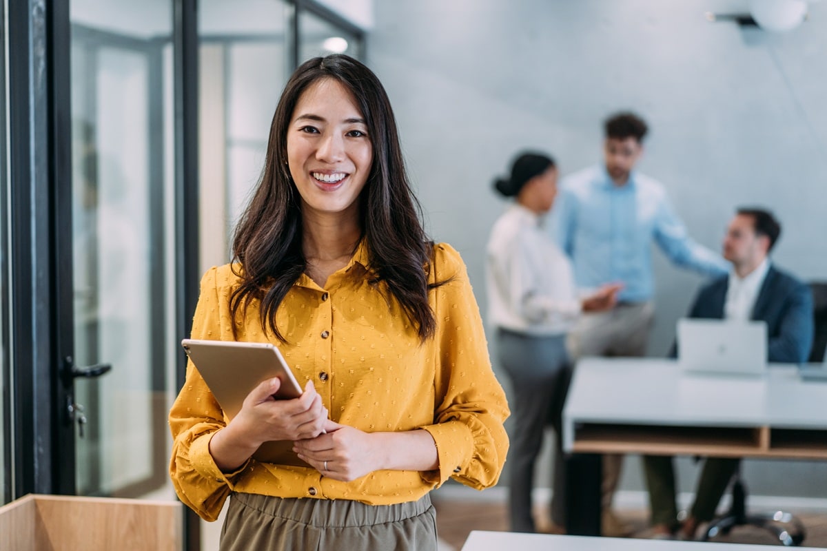 Lady in yellow shirt standing in office 