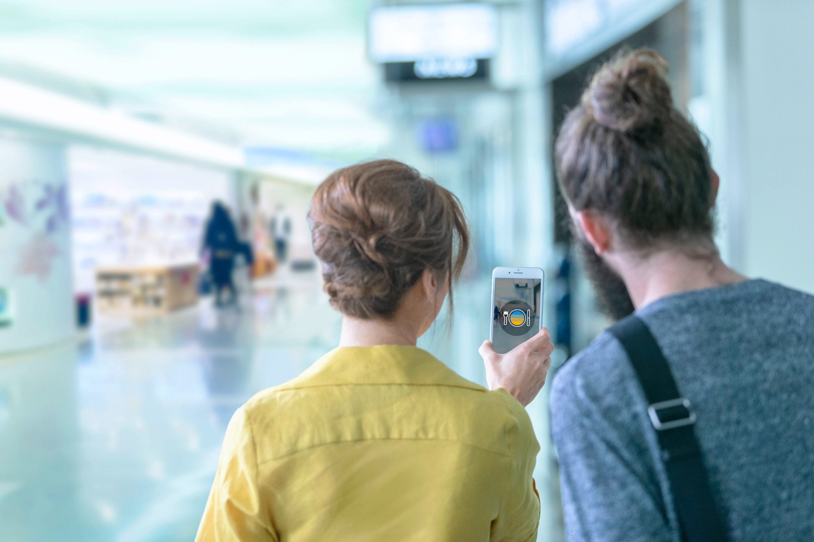 Two ladies looking through a phone screen