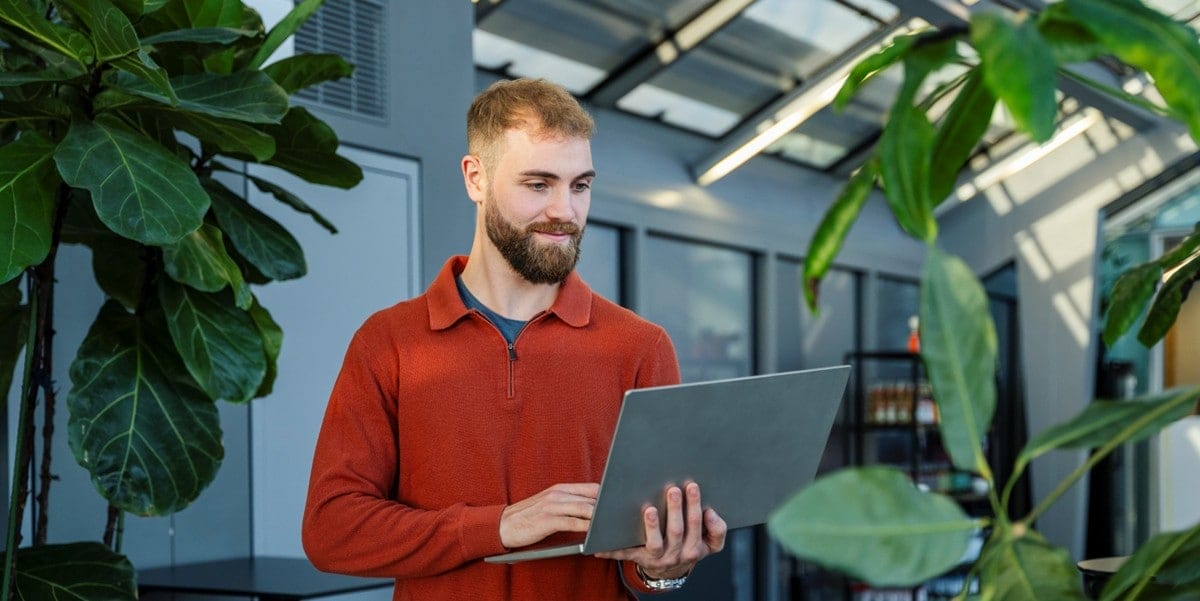 man in office using laptop